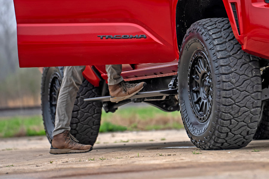 Running board installed on a red pickup