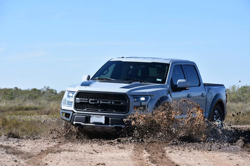 Ford Raptor driving through mud